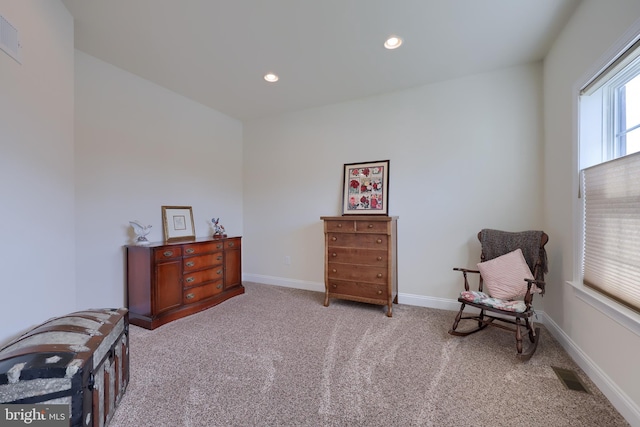 sitting room featuring light carpet