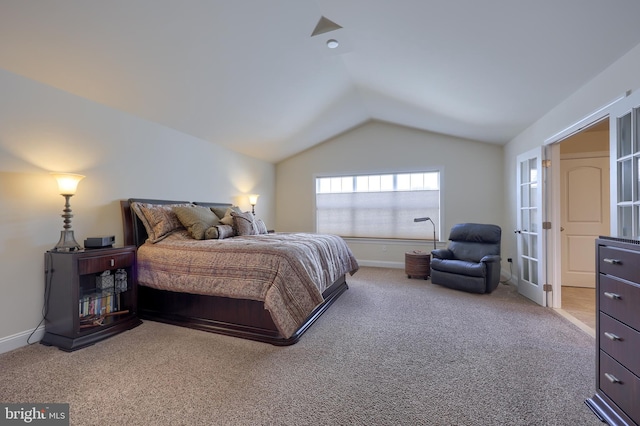 carpeted bedroom with lofted ceiling