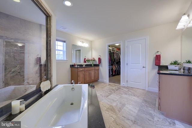 bathroom featuring vanity and a tub