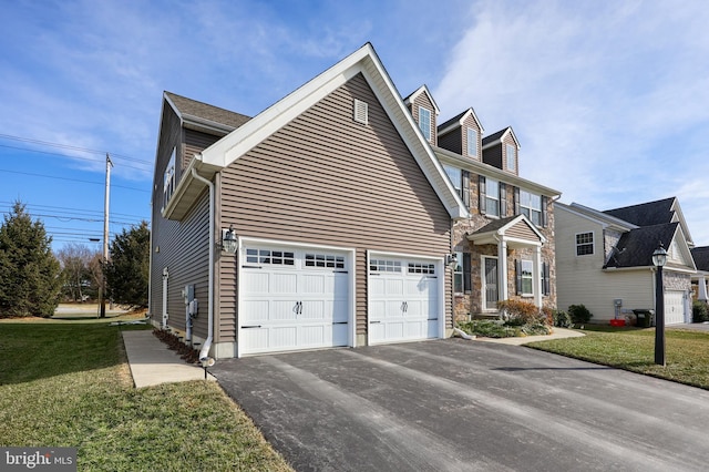 view of front of house featuring a garage and a front lawn