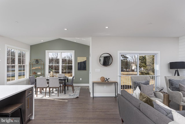 living room featuring vaulted ceiling, dark wood-style flooring, and plenty of natural light