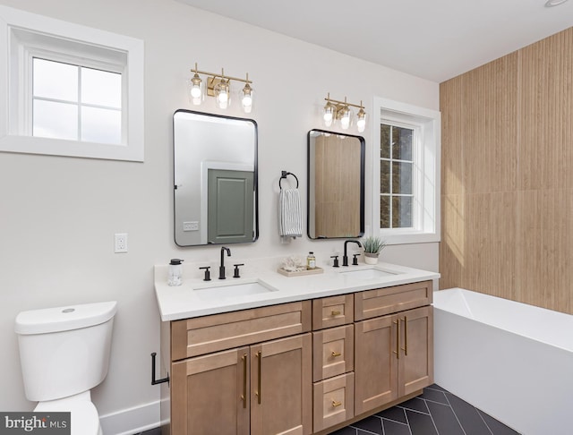 full bathroom featuring plenty of natural light, a sink, and toilet