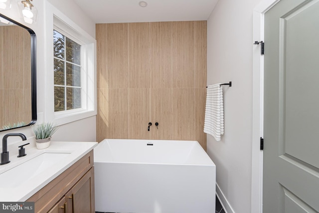 full bathroom featuring a freestanding bath and vanity