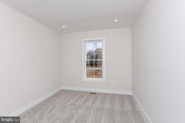 carpeted empty room featuring visible vents, baseboards, and recessed lighting