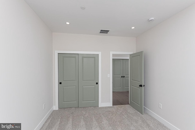 unfurnished bedroom with baseboards, visible vents, carpet flooring, and recessed lighting