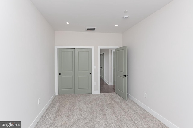 unfurnished bedroom with carpet floors, recessed lighting, visible vents, and baseboards