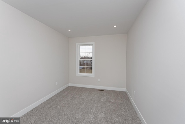 spare room with carpet, baseboards, and recessed lighting