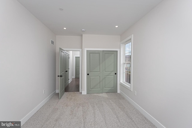 unfurnished bedroom featuring recessed lighting, baseboards, visible vents, and carpet flooring