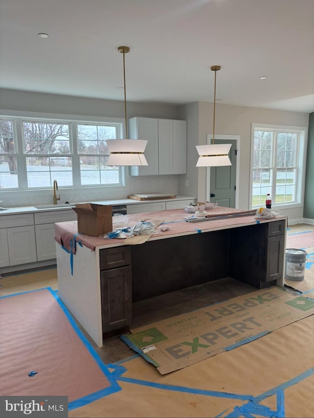 kitchen featuring plenty of natural light, light countertops, and a sink