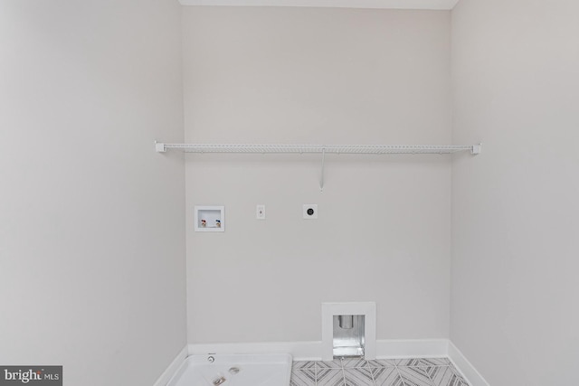 clothes washing area with baseboards, laundry area, hookup for a washing machine, and hookup for an electric dryer