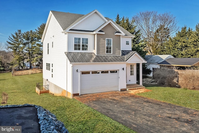 traditional home featuring aphalt driveway, a standing seam roof, metal roof, and an attached garage