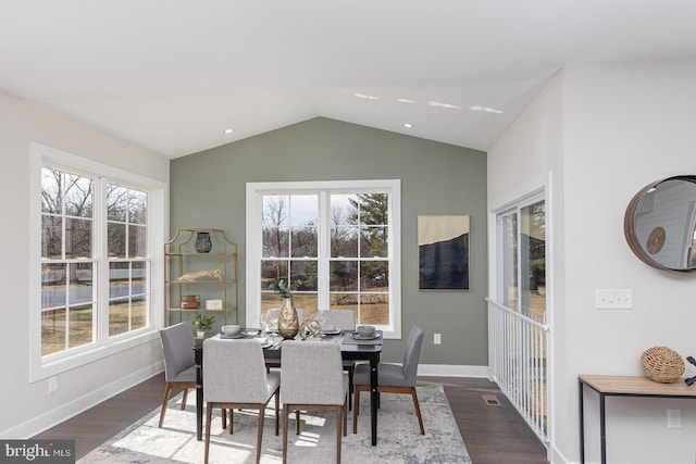 dining room featuring lofted ceiling, wood finished floors, visible vents, and baseboards