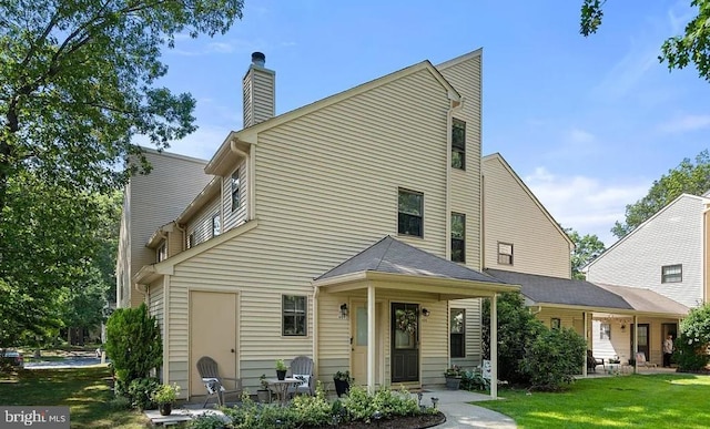 rear view of property with a yard