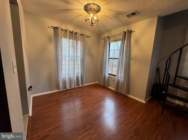 entryway featuring dark hardwood / wood-style floors and a textured ceiling