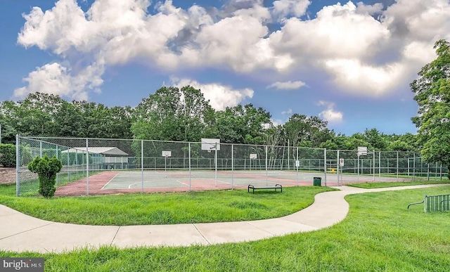 view of property's community featuring tennis court, a yard, and basketball hoop