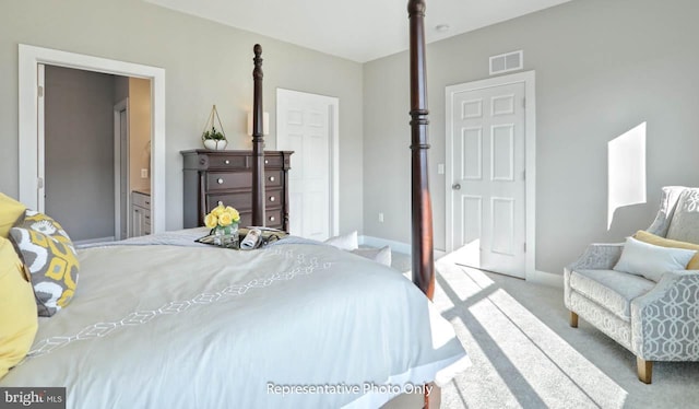 carpeted bedroom with ensuite bath