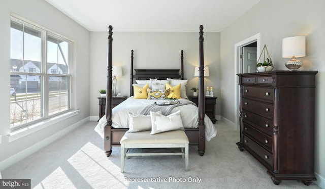 bedroom with multiple windows and light carpet