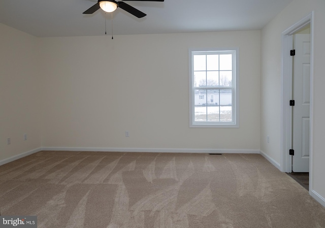 unfurnished room featuring ceiling fan and carpet