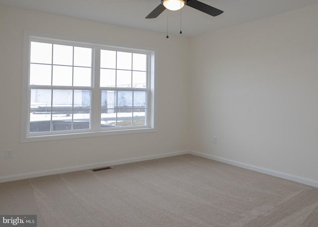 empty room with carpet floors and ceiling fan