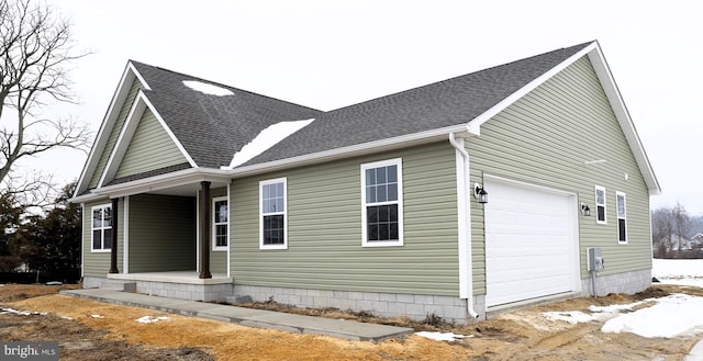 view of side of home with a garage and a porch