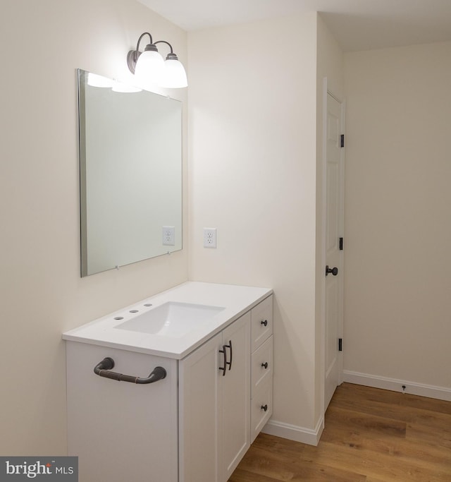 bathroom featuring wood-type flooring and vanity