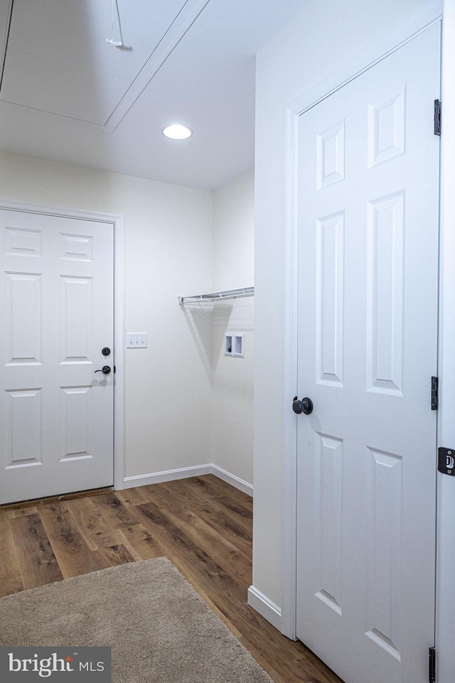 clothes washing area featuring dark hardwood / wood-style flooring and hookup for a washing machine