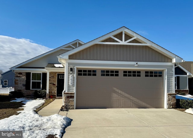 craftsman-style house featuring board and batten siding, stone siding, an attached garage, and concrete driveway