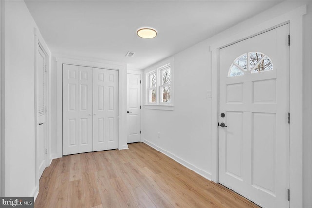 foyer entrance with light hardwood / wood-style flooring