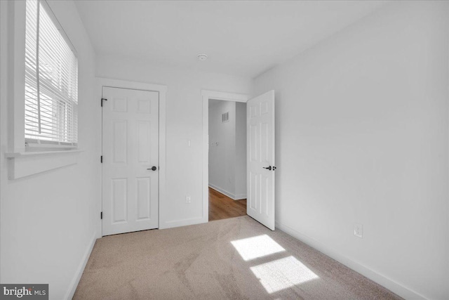 unfurnished bedroom featuring light colored carpet