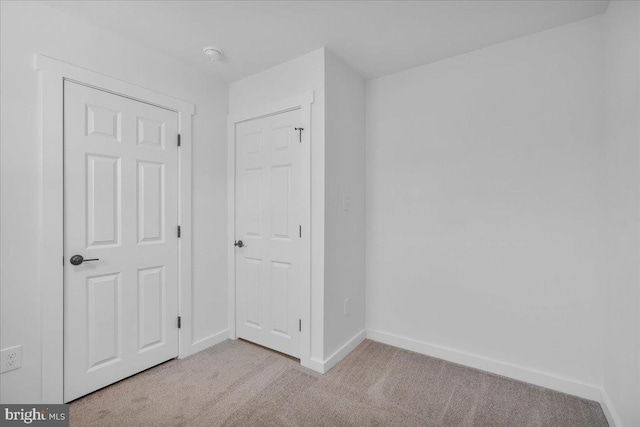 unfurnished bedroom with light colored carpet