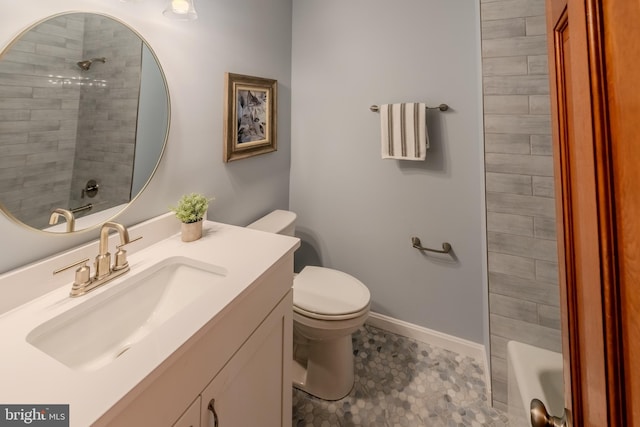 full bathroom featuring vanity, tiled shower / bath combo, and toilet