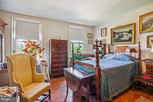 bedroom with dark hardwood / wood-style floors