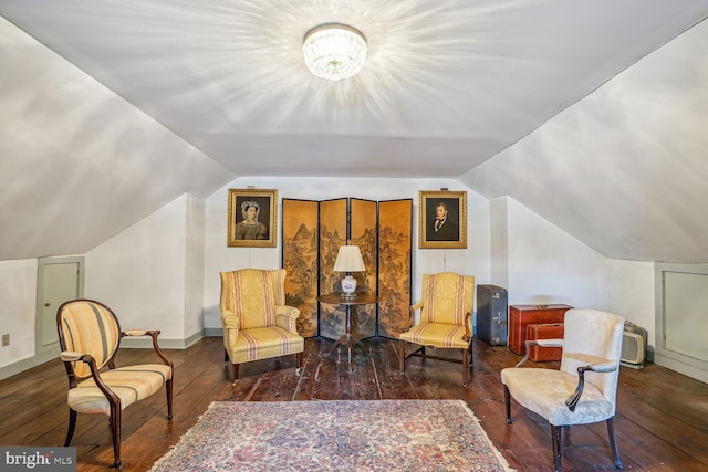 sitting room with dark hardwood / wood-style flooring and lofted ceiling