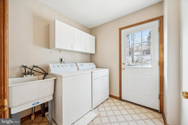 laundry area with cabinets, sink, and washer and clothes dryer