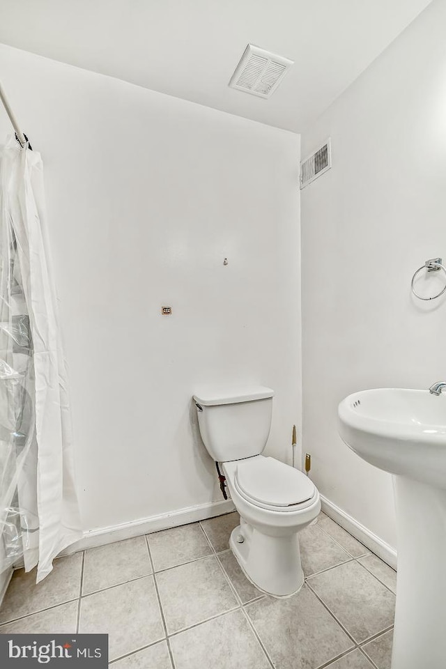 bathroom with sink, tile patterned floors, and toilet