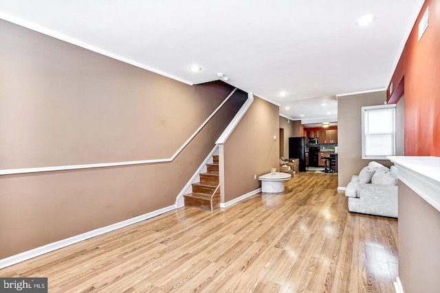 living room featuring ornamental molding and light hardwood / wood-style floors