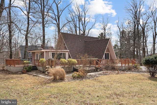 view of home's exterior featuring a yard, a shingled roof, a chimney, and a wooden deck