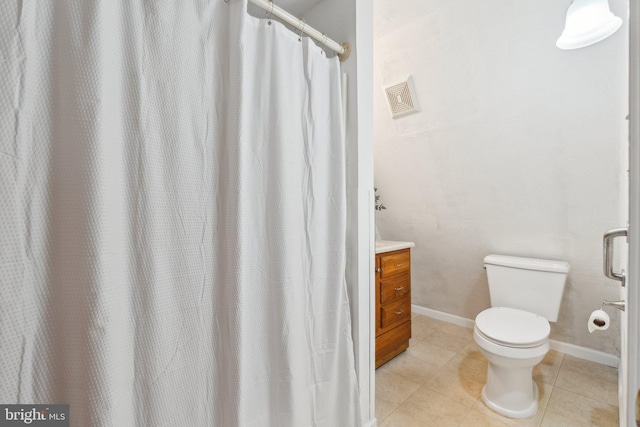 full bathroom featuring tile patterned flooring, baseboards, vanity, and toilet