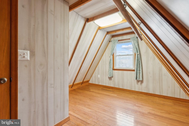 bonus room featuring lofted ceiling and hardwood / wood-style flooring