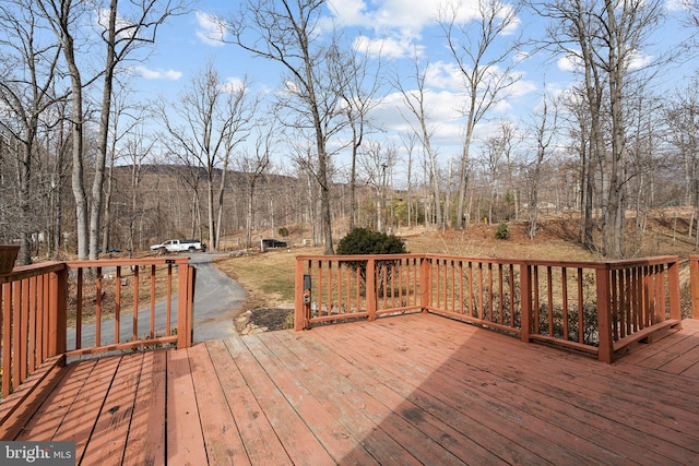 wooden terrace with a wooded view