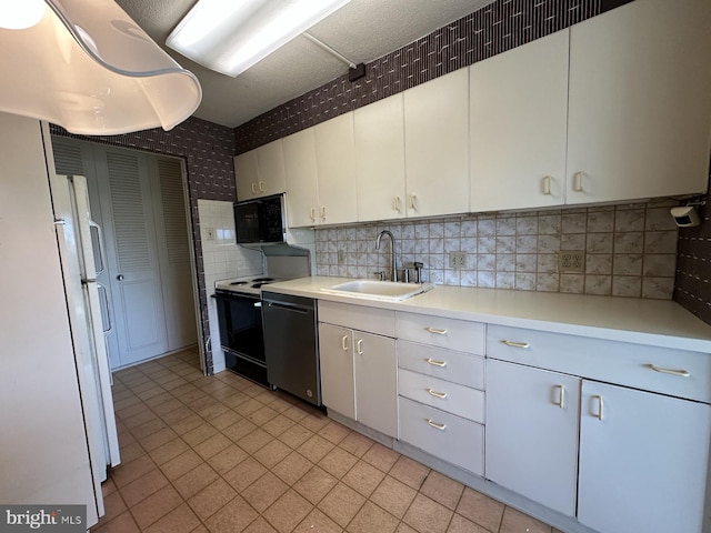 kitchen with tasteful backsplash, sink, white cabinets, and black appliances