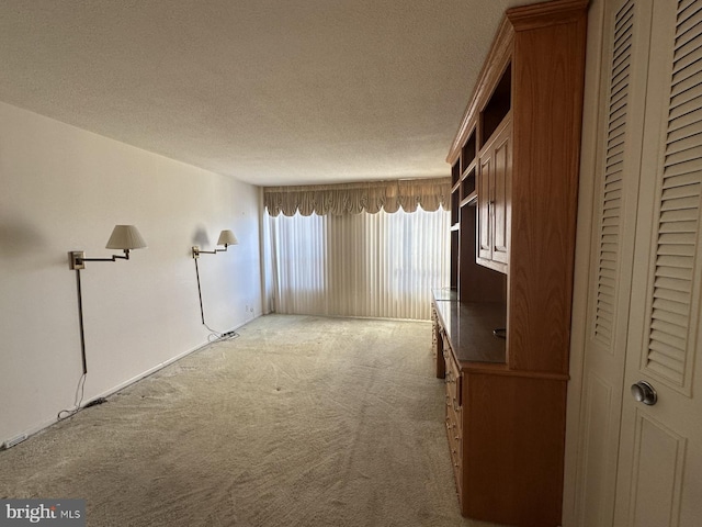 unfurnished room with carpet flooring and a textured ceiling