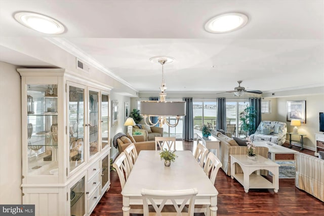 dining area with ornamental molding, ceiling fan, and dark hardwood / wood-style flooring