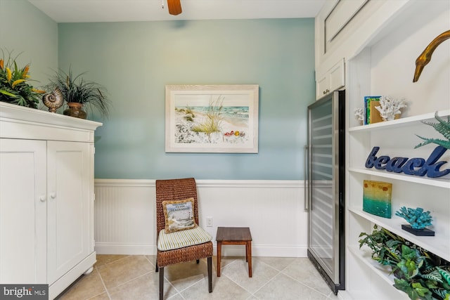 living area with wine cooler, light tile patterned floors, and ceiling fan