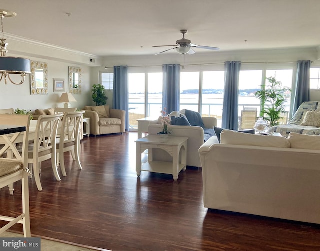 living room featuring a water view, ornamental molding, plenty of natural light, and dark hardwood / wood-style floors