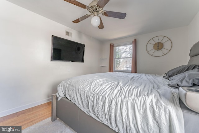 bedroom with ceiling fan and light hardwood / wood-style flooring