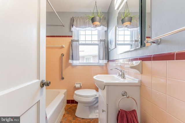 full bathroom with vanity, toilet, shower / washtub combination, and tile walls