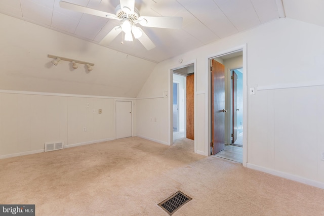 bonus room featuring light carpet, lofted ceiling, and ceiling fan