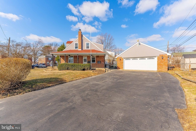 view of front of home featuring a porch, a garage, and a front lawn