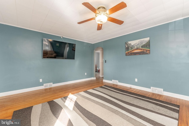 interior space with hardwood / wood-style flooring, ornamental molding, and ceiling fan